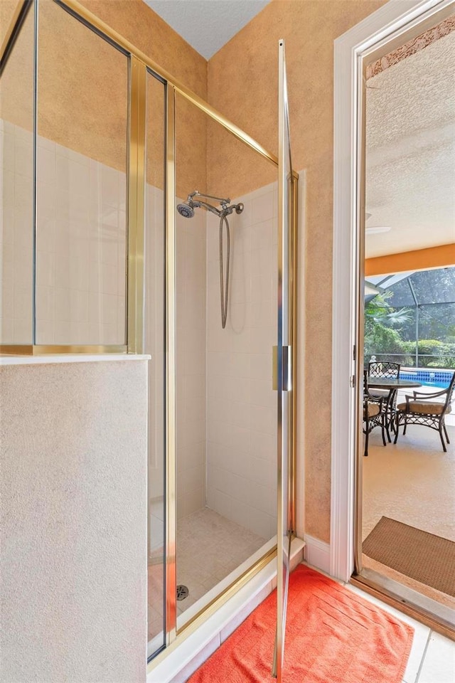 bathroom featuring a shower with shower door