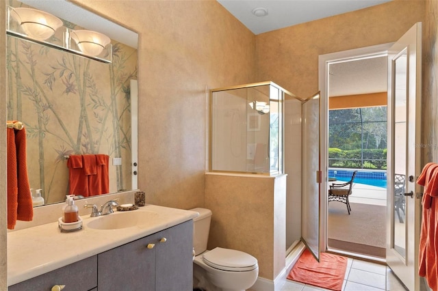 bathroom featuring toilet, vanity, tile patterned floors, and a shower with door