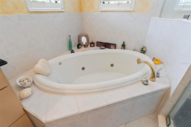 bathroom with a relaxing tiled tub