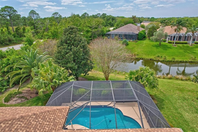 view of pool with glass enclosure, a yard, and a water view