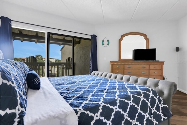 bedroom featuring access to outside and dark hardwood / wood-style flooring