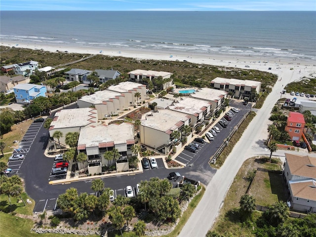 birds eye view of property featuring a water view and a view of the beach