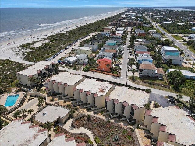 bird's eye view featuring a water view and a beach view