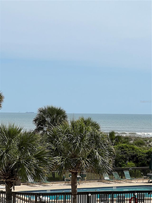 view of swimming pool with a water view