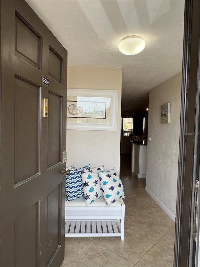 hall with light tile patterned flooring