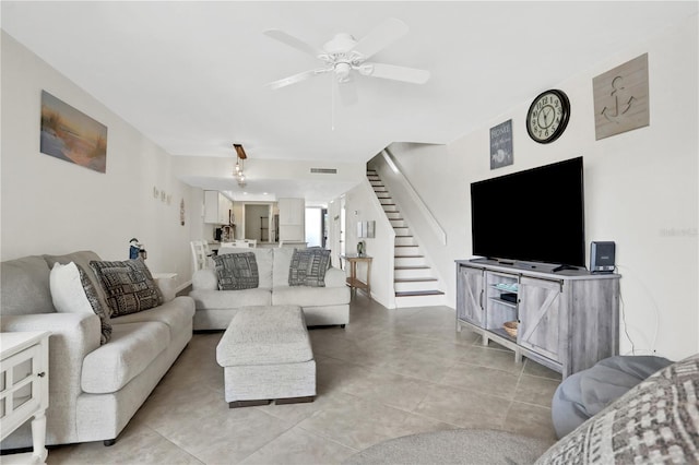 living room with ceiling fan and light tile patterned floors