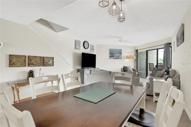 dining space with tile patterned floors and ceiling fan