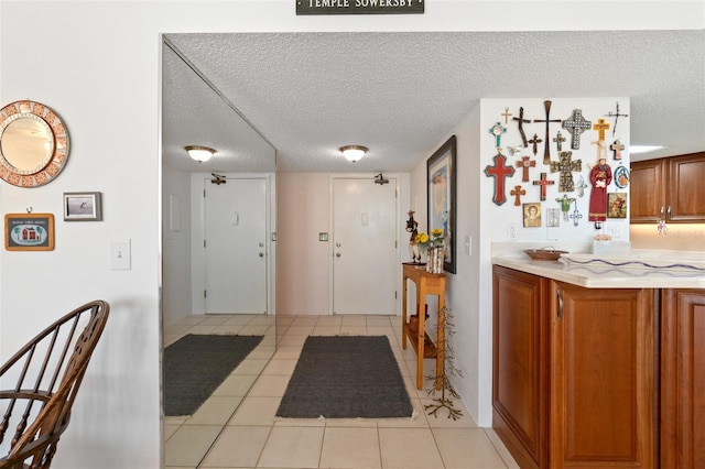 interior space with light tile floors and a textured ceiling