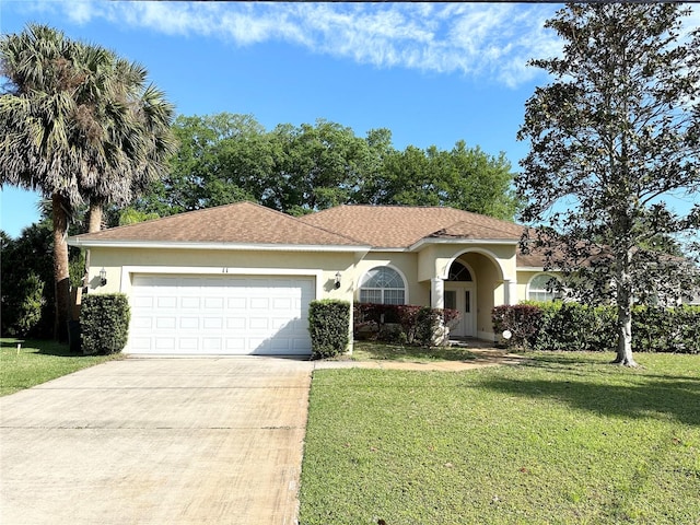 view of front of house with a front lawn and a garage