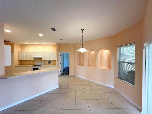 kitchen featuring electric stove, decorative light fixtures, light tile flooring, and white cabinets