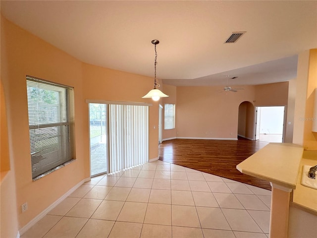 unfurnished room with light tile floors and ceiling fan