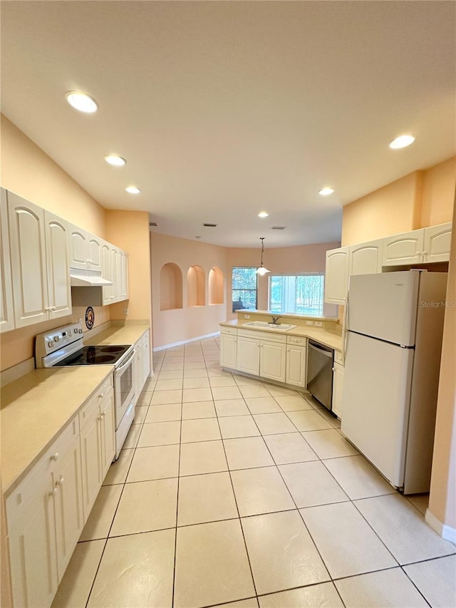 kitchen featuring decorative light fixtures, white cabinetry, white appliances, sink, and light tile floors