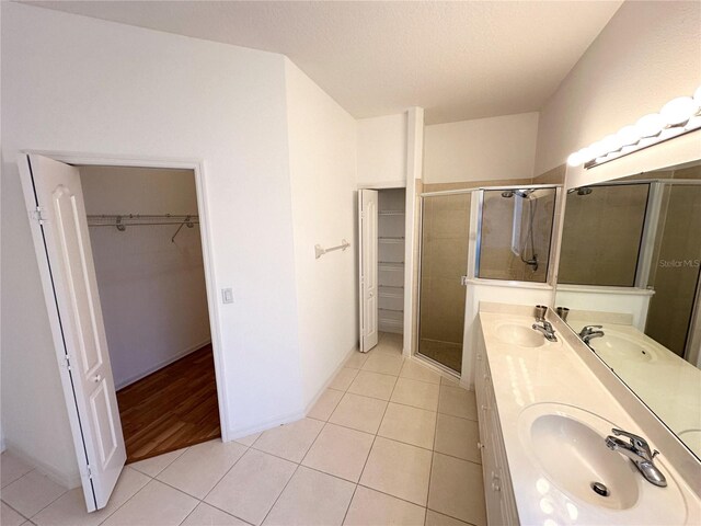 bathroom with walk in shower, wood-type flooring, and dual bowl vanity