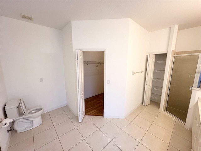 unfurnished bedroom with light tile floors and a closet