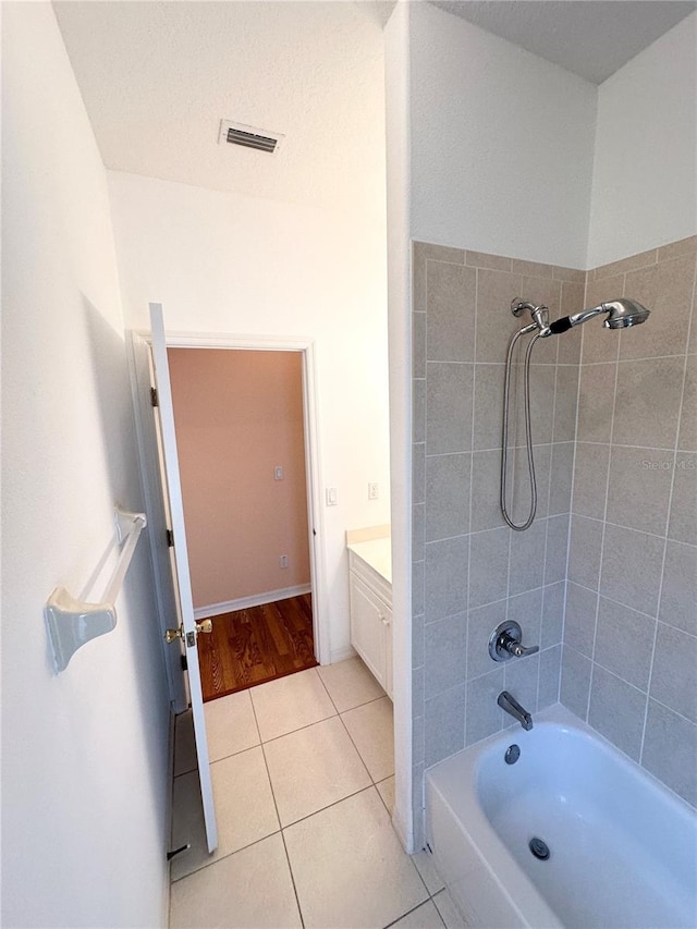 bathroom with vanity, tiled shower / bath combo, and hardwood / wood-style flooring