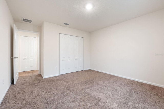 unfurnished bedroom featuring a closet and carpet floors