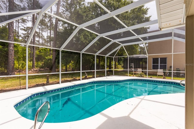 view of swimming pool featuring a lanai and a patio