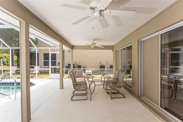 sunroom with a healthy amount of sunlight and ceiling fan