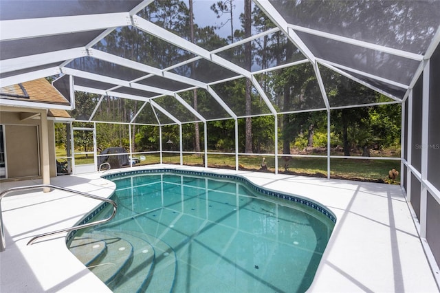 view of pool featuring glass enclosure and a patio area