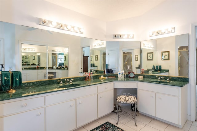 bathroom with tile flooring and vanity