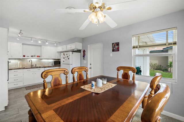 dining area featuring ceiling fan and sink