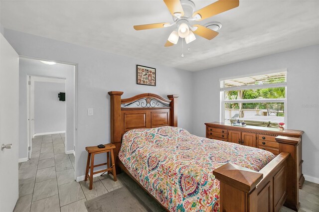 bedroom featuring ceiling fan and light tile patterned flooring