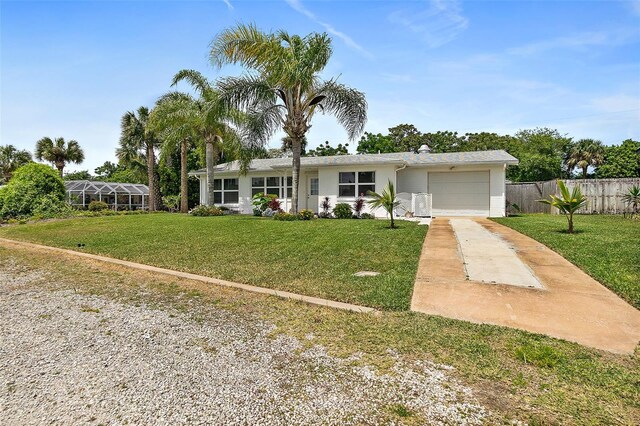 ranch-style house with a garage and a front lawn