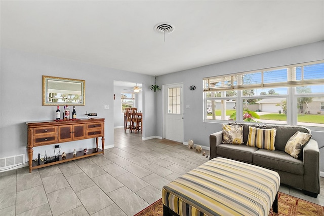 living room with ceiling fan and light tile patterned flooring