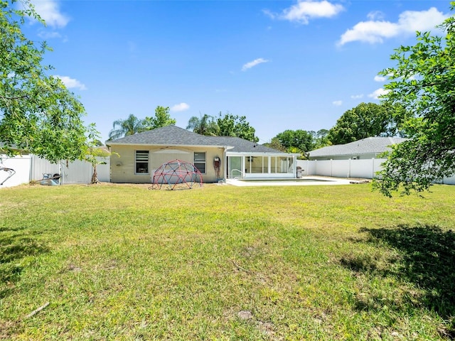 back of house featuring a lawn and a patio