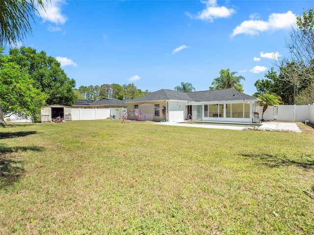 rear view of house featuring a patio area and a lawn