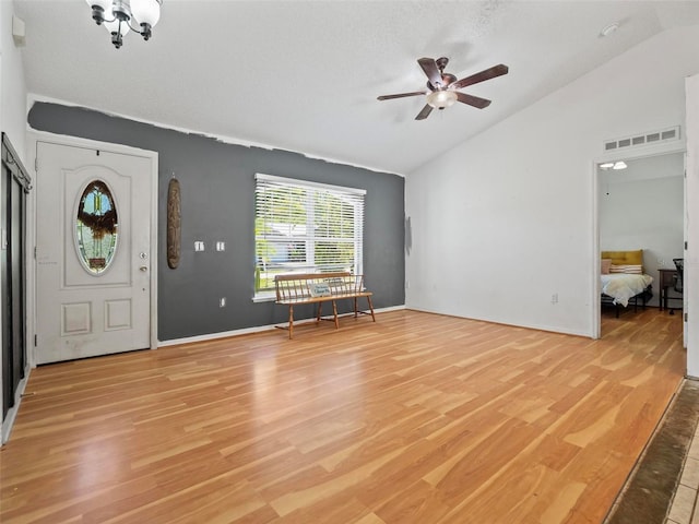 entrance foyer with vaulted ceiling, ceiling fan, and light hardwood / wood-style flooring