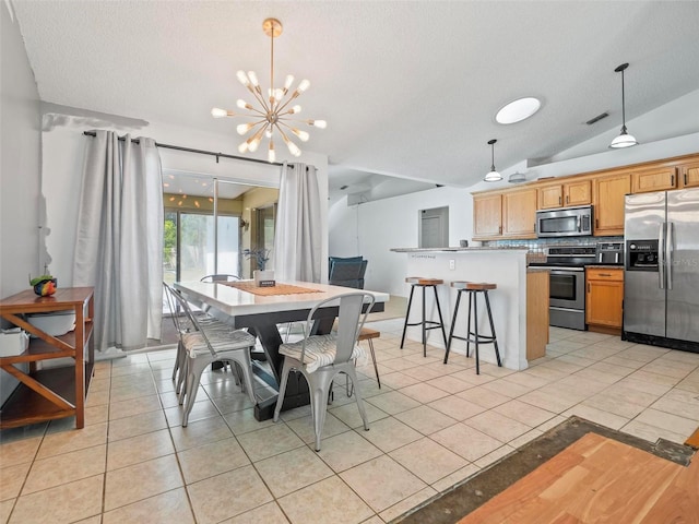 dining room with vaulted ceiling, light tile patterned flooring, an inviting chandelier, and a textured ceiling