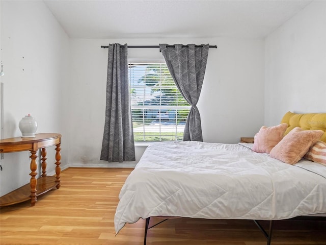 bedroom with hardwood / wood-style flooring