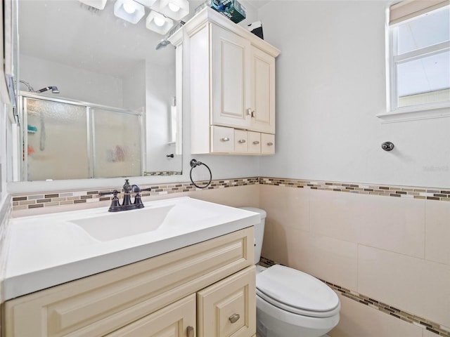 bathroom with toilet, tile walls, walk in shower, and vanity