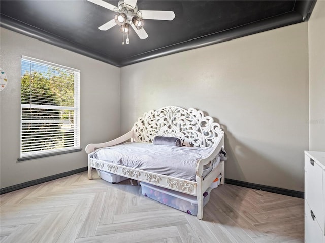 bedroom with ceiling fan, light parquet flooring, and crown molding