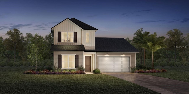 view of front of house with a yard and a garage