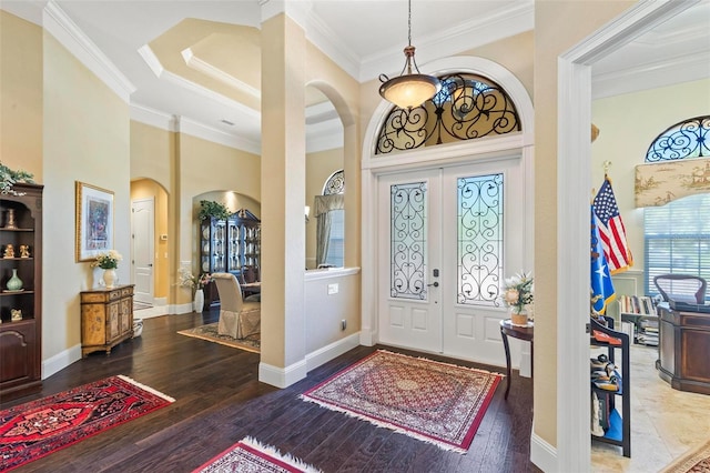 foyer featuring dark hardwood / wood-style floors, french doors, and crown molding