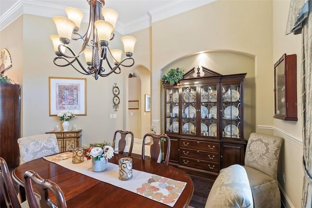 dining area with a chandelier, crown molding, and dark hardwood / wood-style flooring