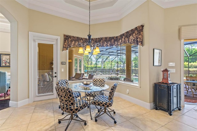 dining space featuring a raised ceiling, crown molding, light tile floors, and an inviting chandelier