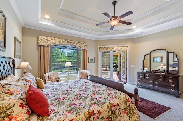 bedroom with light colored carpet, ceiling fan, crown molding, access to outside, and a tray ceiling