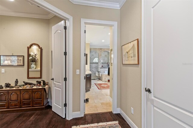 hallway featuring dark tile flooring and ornamental molding