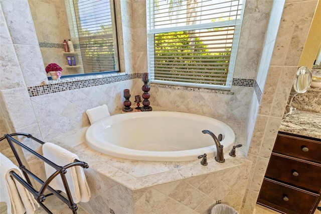 bathroom with a relaxing tiled bath and vanity