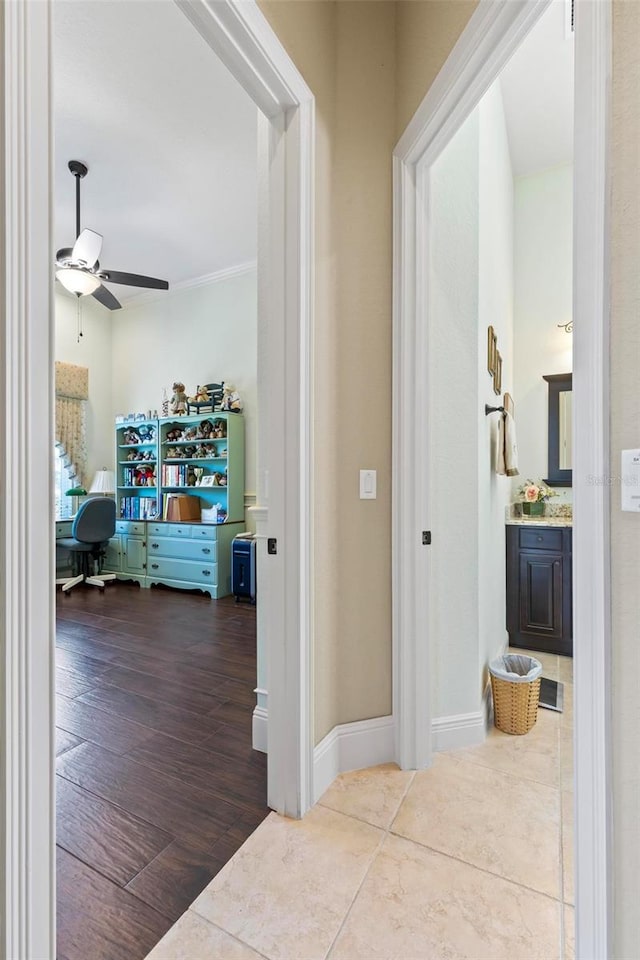 corridor featuring ornamental molding and hardwood / wood-style flooring