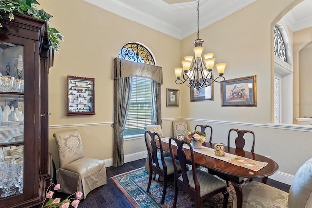 dining space with crown molding, dark wood-type flooring, and a chandelier