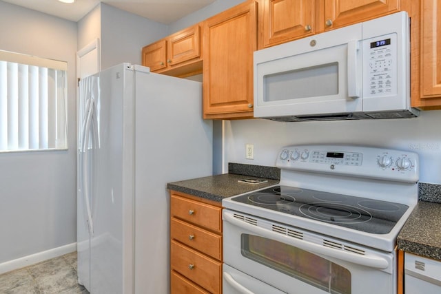 kitchen featuring white appliances and light tile floors