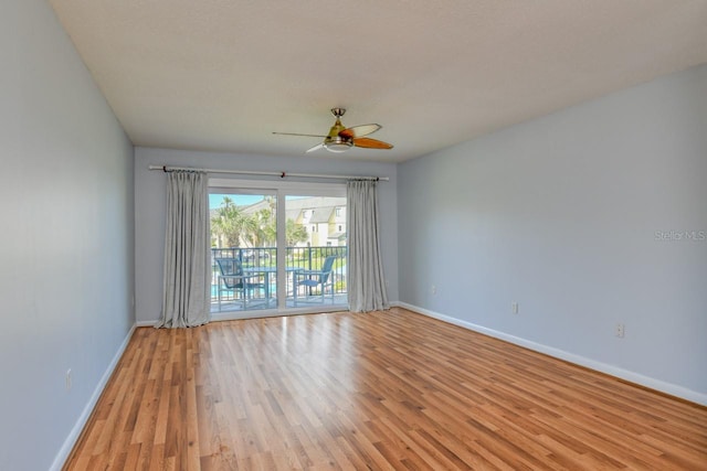 spare room with ceiling fan and light wood-type flooring