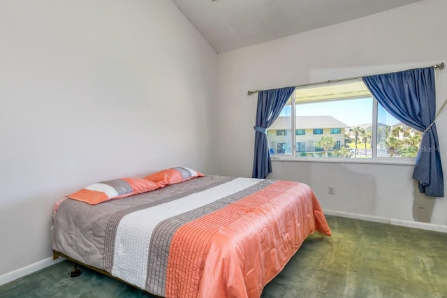 carpeted bedroom with lofted ceiling