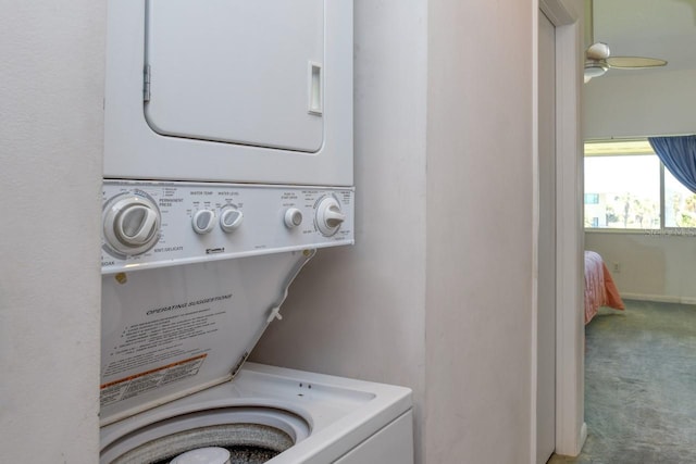 laundry room with stacked washer / dryer, ceiling fan, and carpet flooring