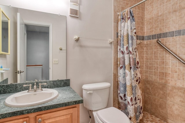 bathroom featuring walk in shower, oversized vanity, and toilet