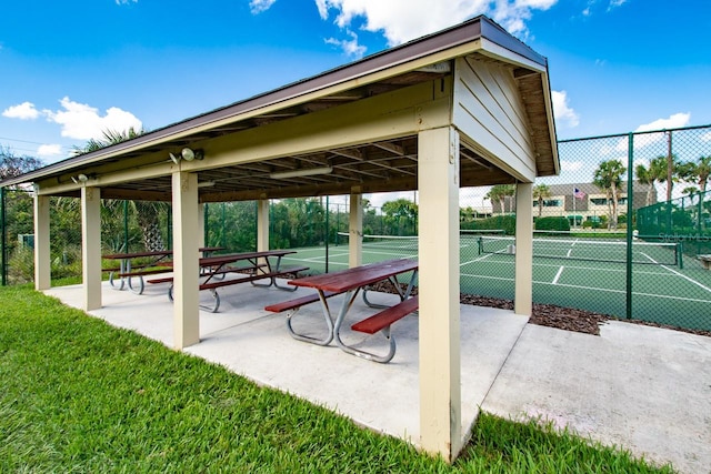 view of property's community with tennis court